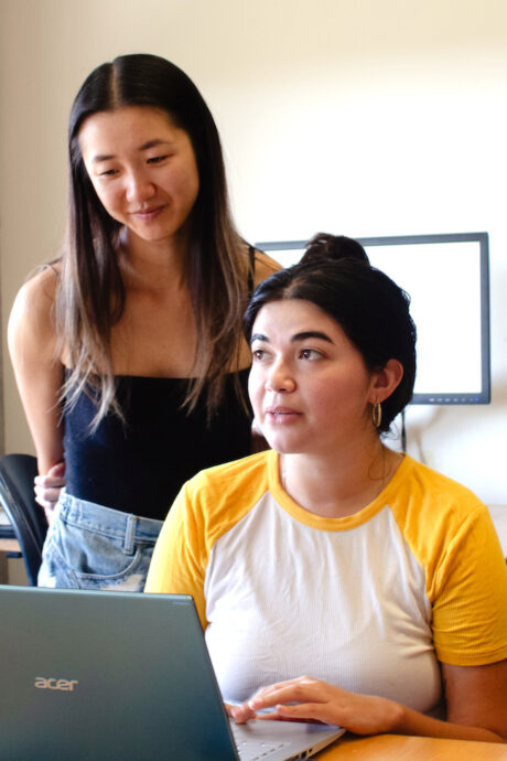 Two women in front of a laptop computer